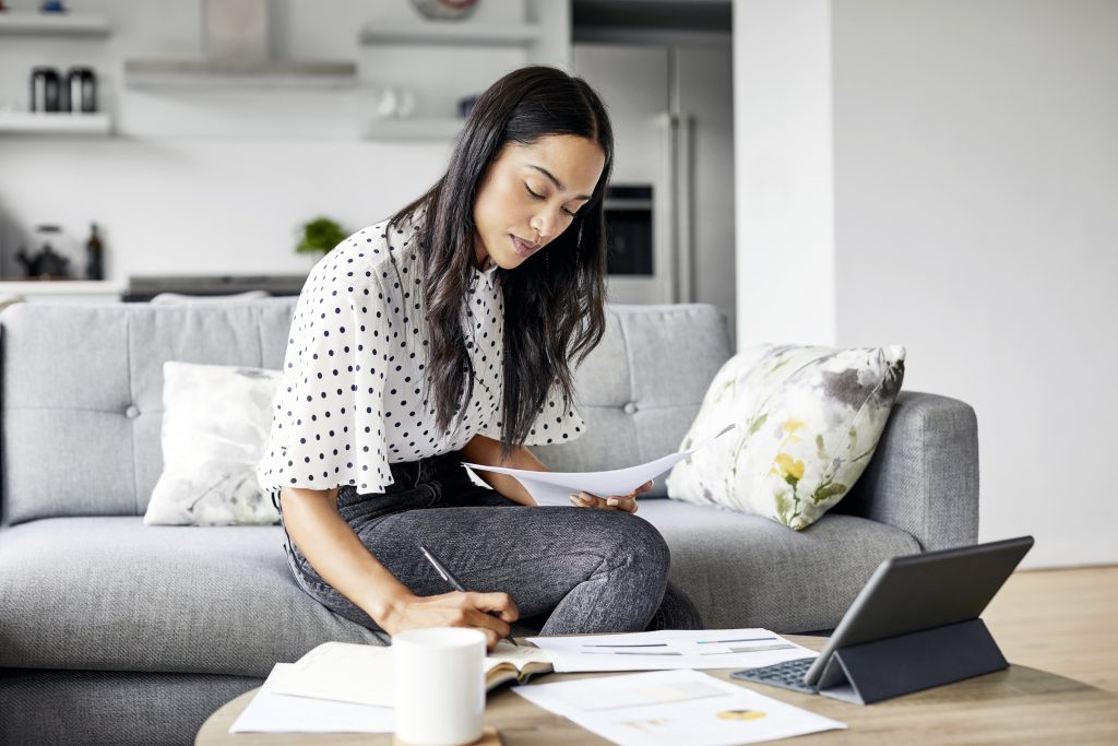 Woman checking her bill documents while sitting at home